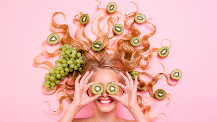 Smiling woman with antioxidant foods in her hair